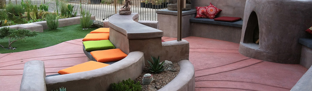 concrete benches and decorative concrete patio with kiva outdoor fireplace
