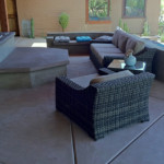 decorative concrete patio with concrete benches and blue pillows