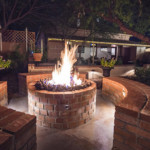 brick outdoor firepit with roaring fire