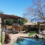 metal shade pergola over patio next to pool