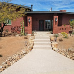 concrete sidewalk with stone paver entrance