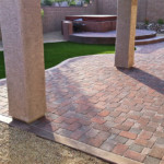 paver patio with synthetic turf yard