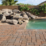red pavers and pool with water feature